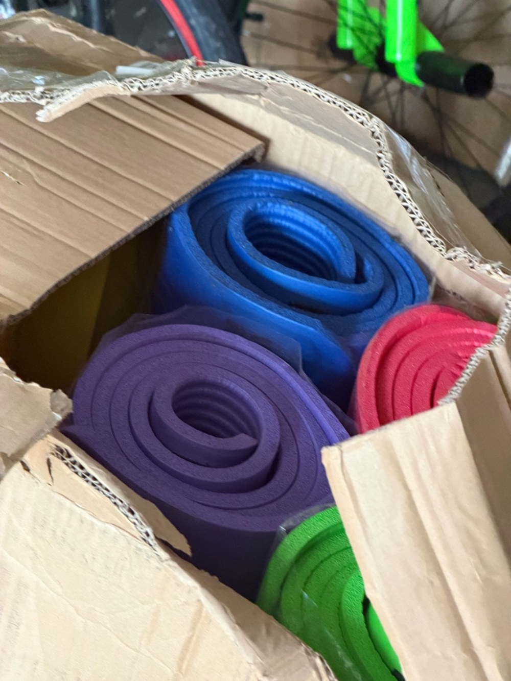 Set of Rolled Yoga Mats in Purple, Blue, Red, Green